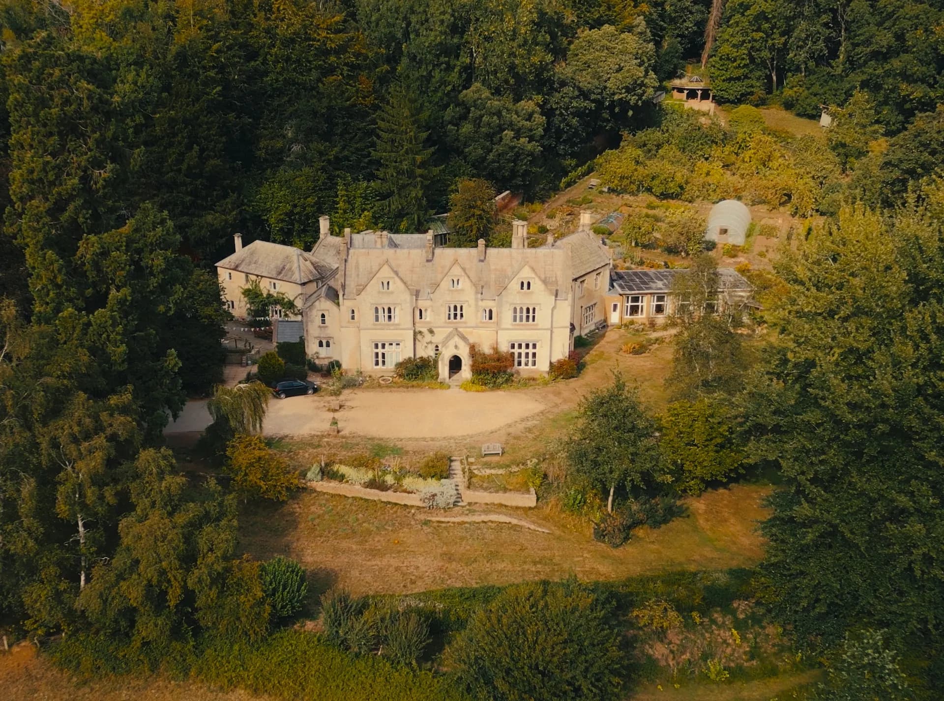 Aerial view of Hawkwood House nestled in woodland in the Cotswolds